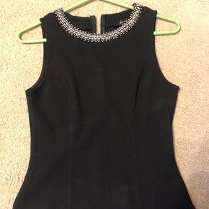 Black peplum top with jeweled collar